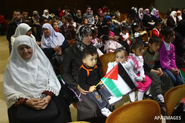 Palestinian children attend a celebration to mark the Orphan Day at al-Shawwa theatre in Gaza city on April 4,2011. Photo by Ashraf Amra