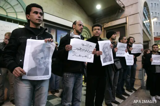 Palestinians hold posters depicting Israeli actor and director, Juliano Mer Khamis, during a protest in the West Bank city of Ramallah April 4, 2011. A masked gunman shot dead on Monday the well-known Israeli actor and d...