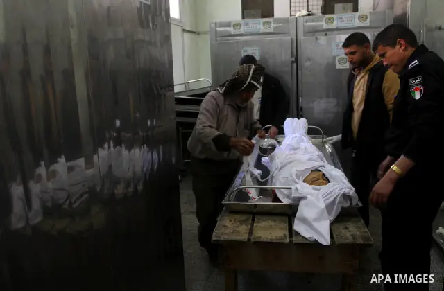Palestinian relatives of Mohammed Shalha, 22-years-old gather around his body inside the morgue at a hospital in Gaza City on April 5, 2011. Palestinian medical officials said they had found the body in the north of Gaza...