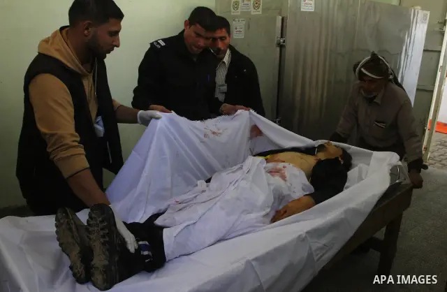Palestinian relatives of Mohammed Shalha, 22-years-old gather around his body inside the morgue at a hospital in Gaza City on April 5, 2011. Palestinian medical officials said they had found the body in the north of Gaza...