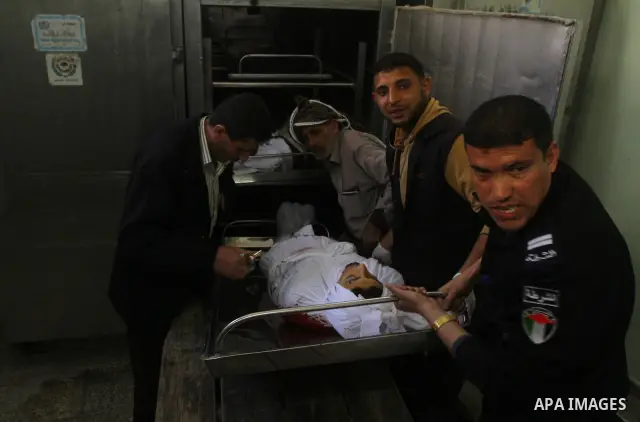 Palestinian relatives of Mohammed Shalha, 22-years-old gather around his body inside the morgue at a hospital in Gaza City on April 5, 2011. Palestinian medical officials said they had found the body in the north of Gaza...