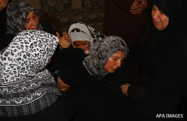Relatives of Palestinian Mohammed Shalha react during his funeral in Jebaliya refugee camp, northern Gaza Strip, Tuesday, April 5, 2011. Palestinian authorities said that Shalha, 21, was killed by Israeli fire along Gaza...