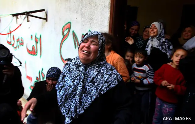 Relatives of Palestinian Mohammed Shalha react during his funeral in Jebaliya refugee camp, northern Gaza Strip, Tuesday, April 5, 2011. Palestinian authorities said that Shalha, 21, was killed by Israeli fire along Gaza...