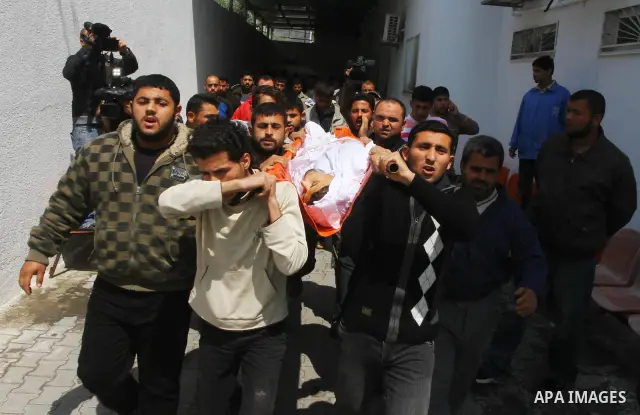 Palestinian mourners carry the body of Mohammed Shalha during his funeral in Jebaliya refugee camp, northern Gaza Strip, Tuesday, April 5, 2011. Palestinian authorities said that Shalha, 21, was killed by Israeli fire al...