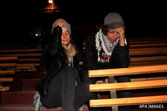Palestinian women also workers in the Freedom Theatre in Jenin, weep on the death of Arab-Israeli actor and director Juliano Mer Khamis during a rally inside the Freedom Theatre, owned by Mer Khamis, in Jenin refugee cam...