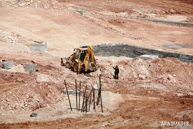 Israeli bulldozers work in the jewish settlement of Pisgat Zeev in East Jerusalem, Tuesday, April 5, 2011. A group of prominent Israelis is presenting an informal new peace proposal, hoping to breathe life into deadlocke...