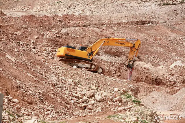 Israeli bulldozers work in the jewish settlement of Pisgat Zeev in East Jerusalem, Tuesday, April 5, 2011. A group of prominent Israelis is presenting an informal new peace proposal, hoping to breathe life into deadlocke...
