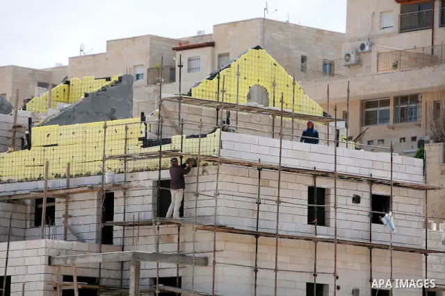 Labourers work in the jewish settlement of Pisgat Zeev in East Jerusalem, Tuesday, April 5, 2011. A group of prominent Israelis is presenting an informal new peace proposal, hoping to breathe life into deadlocked talks w...
