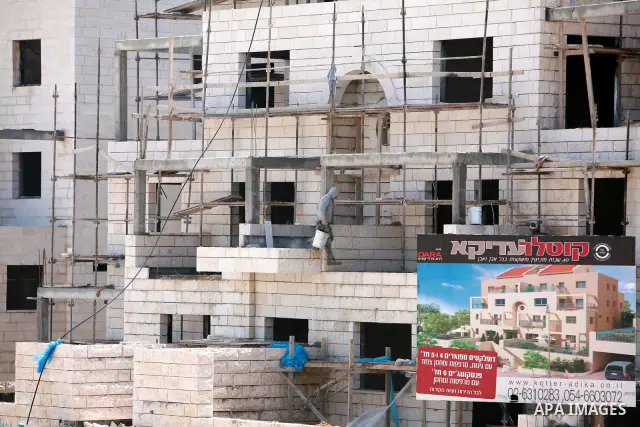 Labourers work in the jewish settlement of Pisgat Zeev in East Jerusalem, Tuesday, April 5, 2011. A group of prominent Israelis is presenting an informal new peace proposal, hoping to breathe life into deadlocked talks w...