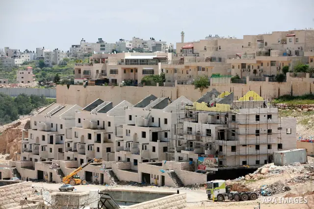 Labourers work in the jewish settlement of Pisgat Zeev in East Jerusalem, Tuesday, April 5, 2011. A group of prominent Israelis is presenting an informal new peace proposal, hoping to breathe life into deadlocked talks w...