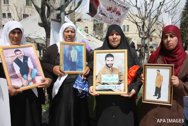 Palestinian women hold pictures of jailed relatives during a protest in the West Bank city of Bethlehem calling for their release from Israeli prisons on April 06, 2011. Photo by Najeh Hashlamoun