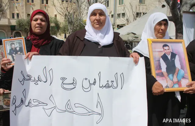 Palestinian women hold pictures of jailed relatives during a protest in the West Bank city of Bethlehem calling for their release from Israeli prisons on April 06, 2011 .Photo by Najeh Hashlamoun