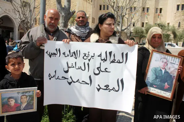 Palestinian women hold pictures of jailed relatives during a protest in the West Bank city of Bethlehem calling for their release from Israeli prisons on April 06, 2011. Photo by Najeh Hashlamoun