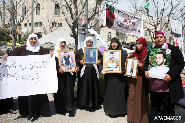 Palestinian women hold pictures of jailed relatives during a protest in the West Bank city of Bethlehem calling for their release from Israeli prisons on April 06, 2011. Photo by Najeh Hashlamoun