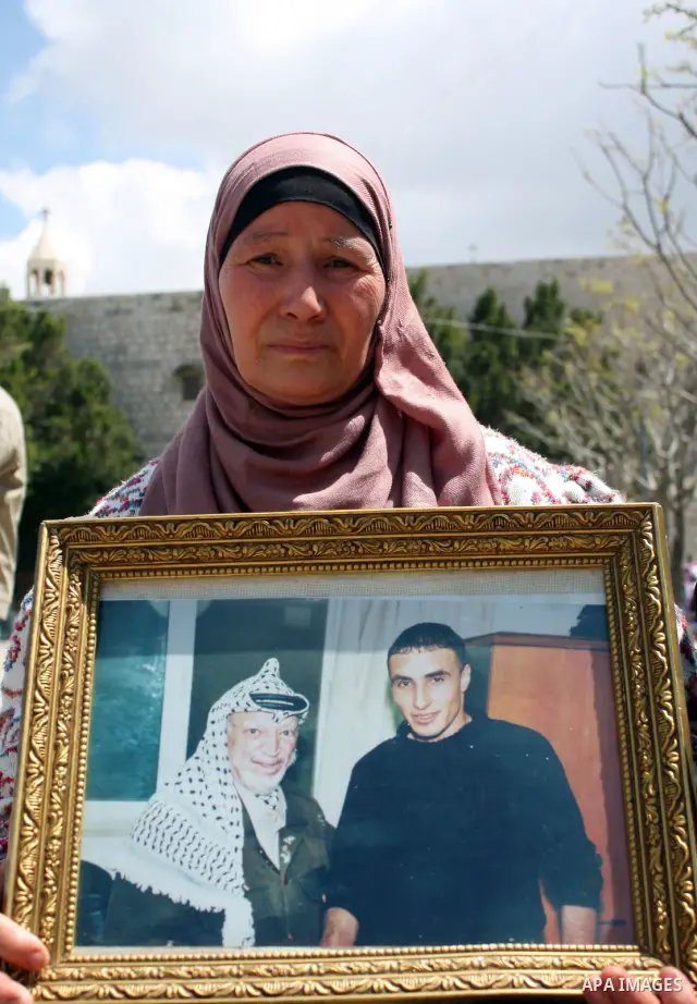 Palestinian women hold pictures of jailed relatives during a protest in the West Bank city of Bethlehem calling for their release from Israeli prisons on April 06, 2011. Photo by Najeh Hashlamoun