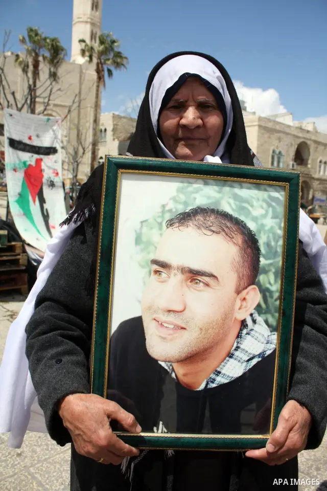 Palestinian women hold pictures of jailed relatives during a protest in the West Bank city of Bethlehem calling for their release from Israeli prisons on April 06, 2011. Photo by Najeh Hashlamoun