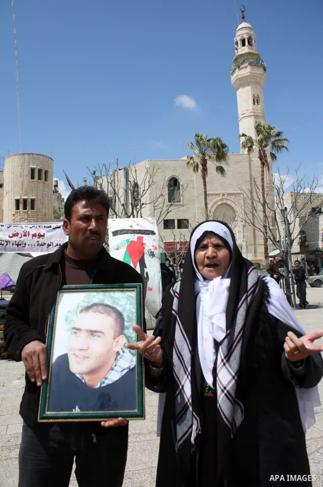 Palestinian women hold pictures of jailed relatives during a protest in the West Bank city of Bethlehem calling for their release from Israeli prisons on April 06, 2011. Photo by Najeh Hashlamoun