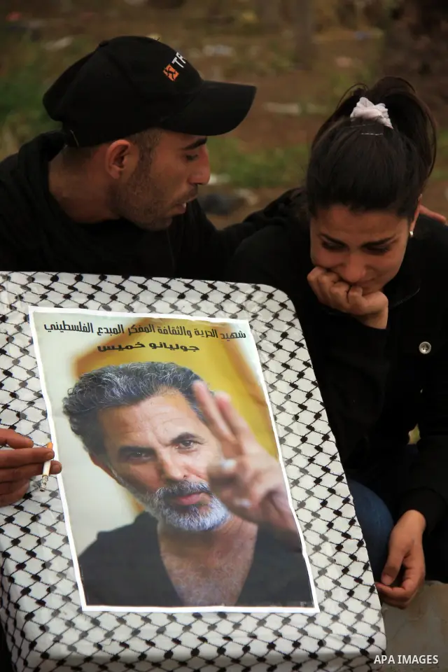 Palestinian Students of Jenin's Freedom Theater weep while waiting for the body of Arab-Israeli actor and director Juliano Mer-Khamis during his funeral at al Jalama Israeli checkpoint between Hayfa City and the West Ban...