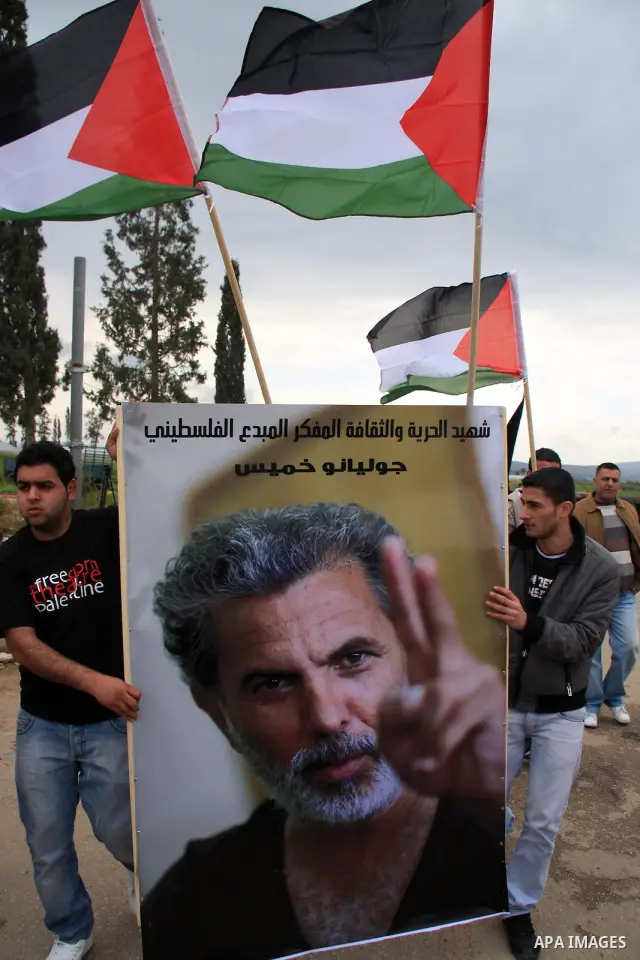 Palestinian Students of Jenin's Freedom Theater weep while waiting for the body of Arab-Israeli actor and director Juliano Mer-Khamis during his funeral at al Jalama Israeli checkpoint between Hayfa City and the West Ban...