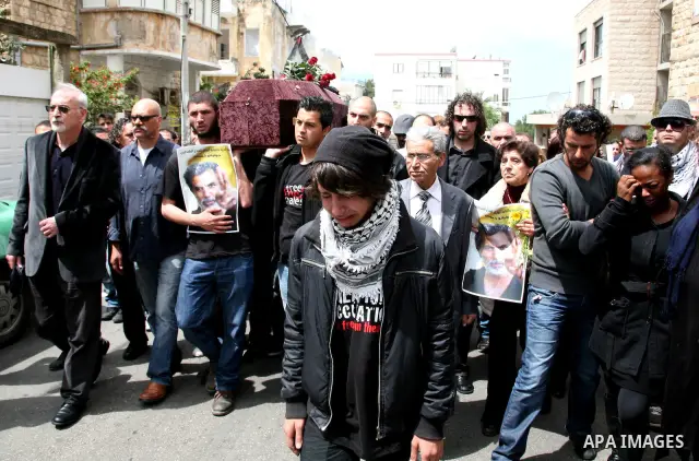 People carry the coffin of Arab-Israeli actor and director Juliano Mer Khamis during a funeral procession near al-Midan theater in the northern Israeli city of Haifa April 6, 2011. Mer-Khamis was gunned down Monday in th...