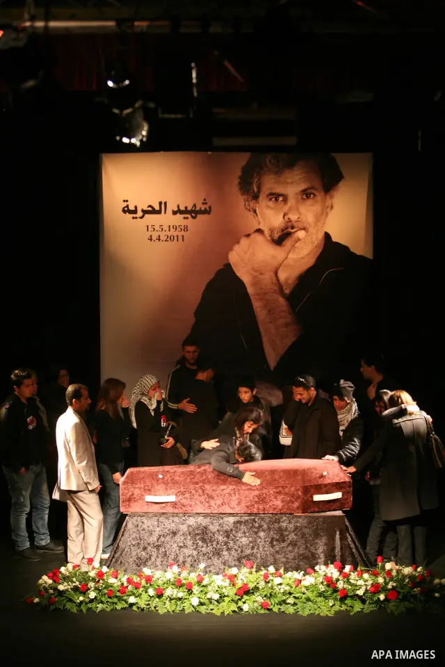 Mourners react as they gather around the coffin of Israeli Palestinian actor, director, filmmaker and political activist Juliano Mer-Khamis, who was shot dead in the West Bank refugee camp of Jenin on Monday, during his...