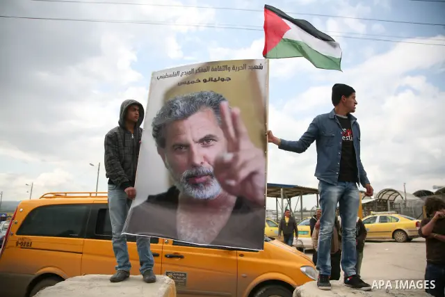 A Palestinian man waits for the arrival of the coffin of Israeli Palestinian actor, director, filmmaker and political activist Juliano Mer-Khamis, who was shot dead in the West Bank refugee camp of Jenin on Monday, durin...