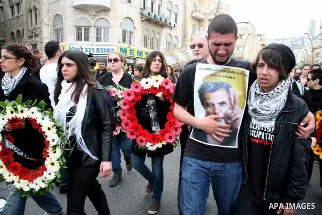 People mourn the Arab-Israeli actor and director Juliano Mer Khamis during a funeral procession near al-Midan theater in the northern Israeli city of Haifa April 6, 2011. Mer-Khamis was gunned down Monday in the West Ban...