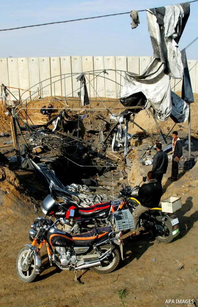 Palestinian men inspect damages at smuggling tunnels which were targeted by Israeli air strikes overnight in Rafah in the south of the Gaza Strip at the border with Egypt on April 7, 2011. Photo By Abed Rahim Khatib