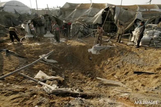Palestinian men inspect damages at smuggling tunnels which were targeted by Israeli air strikes overnight in Rafah in the south of the Gaza Strip at the border with Egypt on April 7, 2011. Photo By Abed Rahim Khatib
