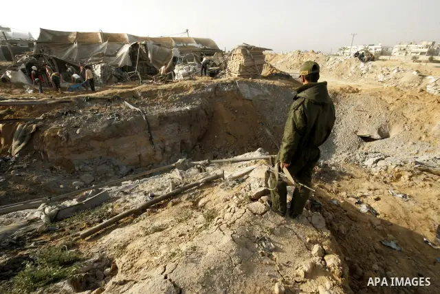 Palestinian men inspect damages at smuggling tunnels which were targeted by Israeli air strikes overnight in Rafah in the south of the Gaza Strip at the border with Egypt on April 7, 2011. Photo By Abed Rahim Khatib