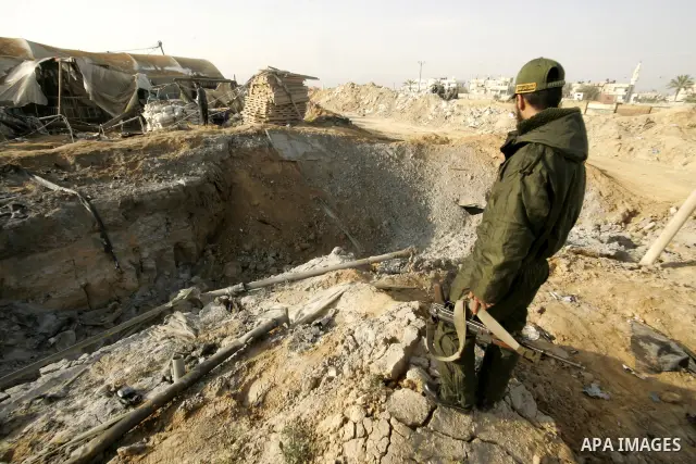 Palestinian men inspect damages at smuggling tunnels which were targeted by Israeli air strikes overnight in Rafah in the south of the Gaza Strip at the border with Egypt on April 7, 2011. Photo By Abed Rahim Khatib