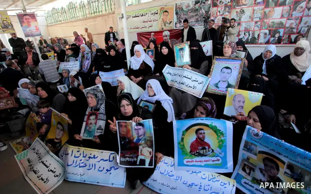 Palestinians hold pictures of jailed relatives during a protest in Gaza city calling for their release from Israeli prisons on April 7, 2011. Photo by Ashraf Amra