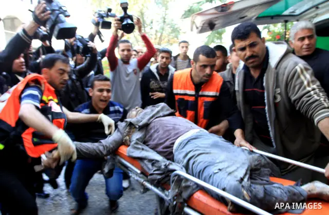 A wounded Palestinian man is carried by his relatives at the al-Shifa hospital after his house was hit by Israeli shell fired towards Gaza Strip near the border between eastern Gaza city and Israel, Wednesday, April 7, 2...