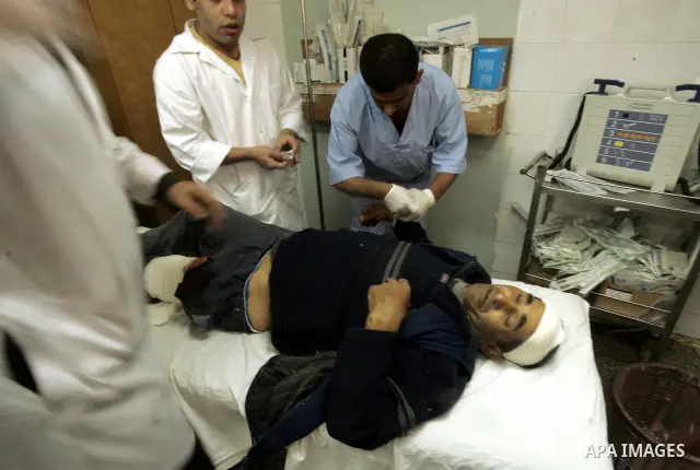 A wounded Palestinian man recieve treatment by medics at the al_Najar hospital in the southern Gaza Strip, Wednesday, April 7, 2011, after his house was hit by Israeli shell fired towards Gaza Strip near the border betwe...