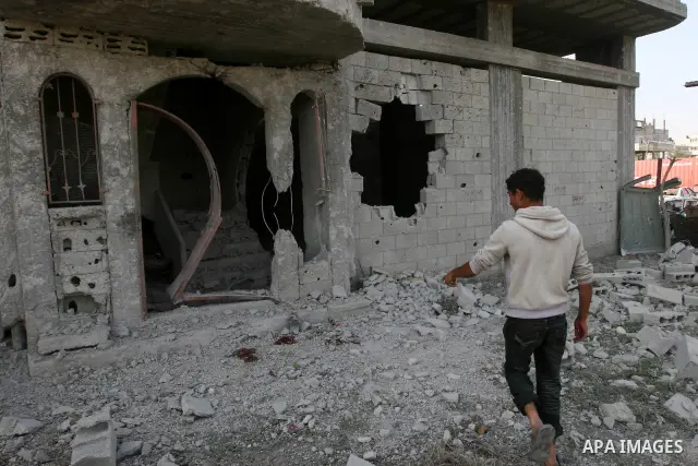 Palestinian children stand next the damaged house after an Israeli airstrike east of Gaza City, Thursday, April 7, 2011. An anti-tank missile fired from the Gaza Strip struck a school bus in southern Israel Thursday, wou...