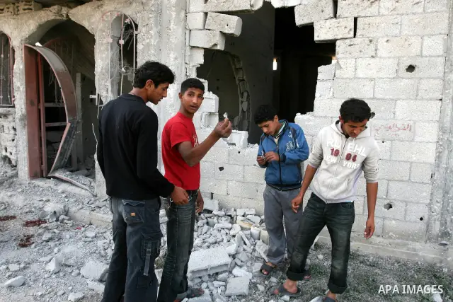 Palestinian children stand next the damaged house after an Israeli airstrike east of Gaza City, Thursday, April 7, 2011. An anti-tank missile fired from the Gaza Strip struck a school bus in southern Israel Thursday, wou...