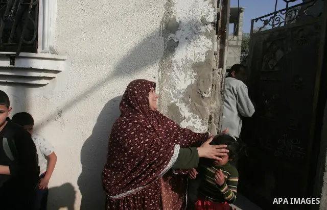 A Palestinian woman cries after her house was destroyed in an explosion that hit the nearby Hamas police training camp in Beit Lahia on April 7, 2011 after Israeli troops shelled two separate areas in Gaza, killing one p...