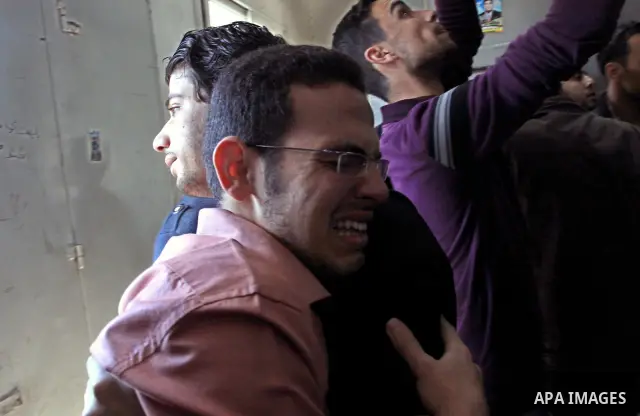 Palestinian mourn their relative who killed by Israeli shell at a morgue in al-Shifa hospital in Gaza city, April 7, 2011. After a Palestinian mortar shell from the Gaza Strip struck a school bus in southern Israel Thurs...