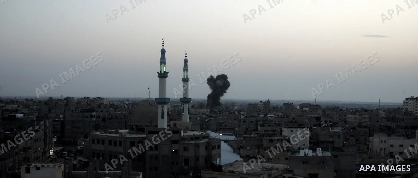 Smoke billows behind buildings from smuggling tunnels linking the southern Gaza Strip to Egypt targeted by an Israeli raid in the town of Rafah on April 7, 2011 killing two people and wounding 14. The shelling came short...