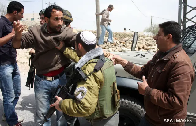 Protesters argue with an Israeli soldier during a demonstration against Israel's controversial separation barrier in the West Bank village of Maasarah, near the biblical town of Bethlehem on April 08, 2011.Israel says th...