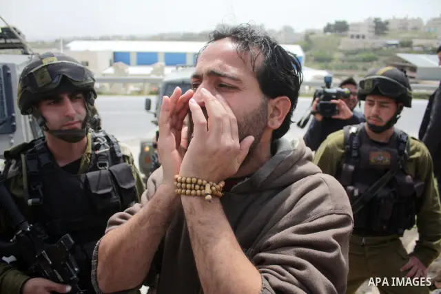 Protesters argue with an Israeli soldier during a demonstration against Israel's controversial separation barrier in the West Bank village of Maasarah, near the biblical town of Bethlehem on April 08, 2011.Israel says th...