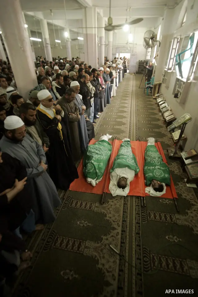 Palestinians pray next to bodies of Hamas militants during their funeral in Rafah in the southern Gaza Strip April 8, 2011. Israeli air strikes in the Gaza Strip killed two militants from the Islamist group Hamas and thr...