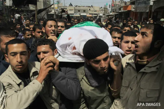 Palestinian mourners carry the body of Motaz Abu Jameh during his funeral in the southern Gaza Strip town of Khan Yunis on April 8, 2011 after Israeli warplanes pounded the coastal strip, killing at least three civilians...