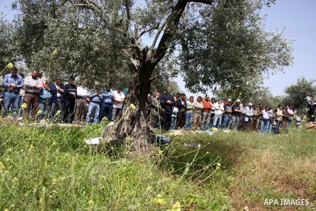 Palestinian protestors attend Friday prayers during the weekly demonstration against Israel's separation barrier in the West Bank village of Nilin, near Ramallah, Friday, April 8, 2011. Israel says the barrier is necessa...