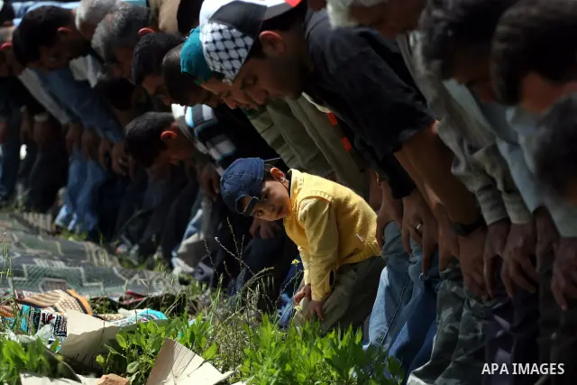Palestinian protestors attend Friday prayers during the weekly demonstration against Israel's separation barrier in the West Bank village of Nilin, near Ramallah, Friday, April 8, 2011. Israel says the barrier is necessa...