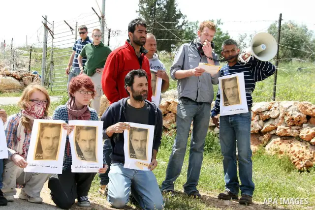 Palestinian protestors take part in the weekly demonstration against Israel's separation barrier in the West Bank village of Bilin, near Ramallah, Friday, April 8, 2011. Israel says the barrier is necessary for security...