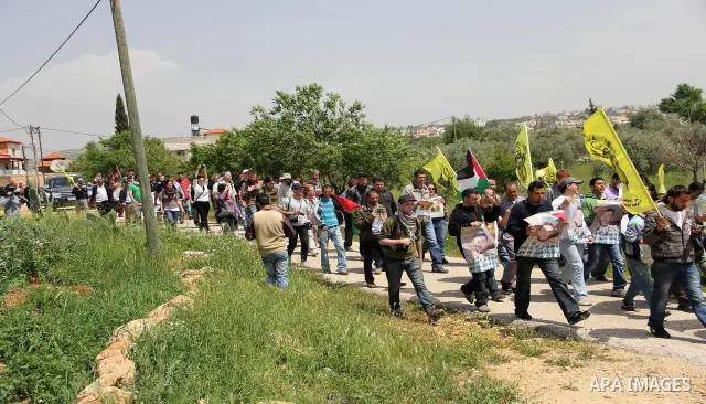 Palestinian protestors take part in the weekly demonstration against Israel's separation barrier in the West Bank village of Bilin, near Ramallah, Friday, April 8, 2011. Israel says the barrier is necessary for security...