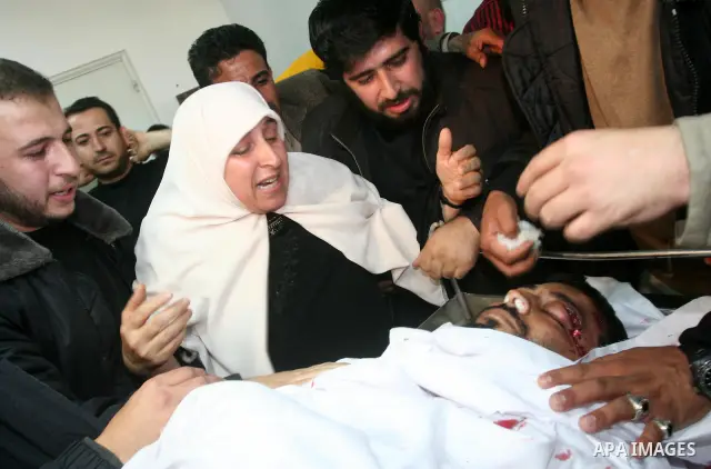 Palestinian relatives of the militant Raed Shehada weep in a hospital in Gaza City on April 8, 2011 after he was killed in an Israeli air strike on northern Gaza, a spokesman for the Palestinian emergency services. Photo...