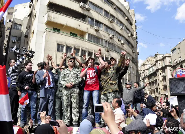 Egyptian officers take part in a protest calling the Field Marshal Hussein Tantawi to step down in Cairo's central Tahrir Square, the focal point of Egyptian uprising, during a protest demanding prosecution of Mubarak an...