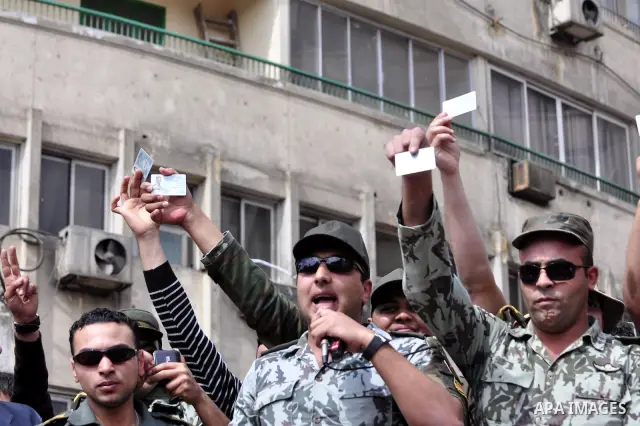 Egyptian officers take part in a protest calling the Field Marshal Hussein Tantawi to step down in Cairo's central Tahrir Square, the focal point of Egyptian uprising, during a protest demanding prosecution of Mubarak an...